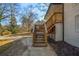 Backyard showing stairs to the raised deck, concrete patio, and the lawn at 1890 Carla Dr, Morrow, GA 30260