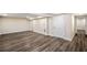 Finished basement with wood-look flooring and a white door leading to another room at 1890 Carla Dr, Morrow, GA 30260