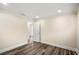 Bedroom view with wood-look flooring, white trim, and a doorway leading to another room at 1890 Carla Dr, Morrow, GA 30260