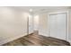 Bedroom view showcasing wood-look flooring, a sliding door closet, and an open doorway at 1890 Carla Dr, Morrow, GA 30260