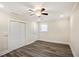 Bedroom featuring hardwood floors, a ceiling fan, and ample closet space at 1890 Carla Dr, Morrow, GA 30260