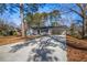 Single-story home featuring a spacious driveway, carport, and a classic white exterior at 1890 Carla Dr, Morrow, GA 30260