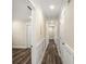 Bright hallway featuring clean white trim, modern flooring, and neutral wall paint at 1890 Carla Dr, Morrow, GA 30260