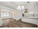 Eat-in kitchen with white cabinets that opens to the dining and living spaces at 1890 Carla Dr, Morrow, GA 30260