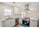 Renovated kitchen showcasing stainless steel appliances, modern white cabinetry and stone countertops at 1890 Carla Dr, Morrow, GA 30260