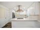 Modern kitchen featuring white cabinets, a cooktop island, and stainless hood at 1890 Carla Dr, Morrow, GA 30260