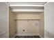 Empty laundry closet with white bi-fold doors, offering space for washer/dryer hookups and storage at 1890 Carla Dr, Morrow, GA 30260