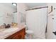 Cozy bathroom with marble countertops, a shower with curtain, and a wood vanity at 2333 Sheridan Ct, Villa Rica, GA 30180