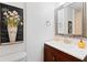 Elegant bathroom featuring dark wood vanity and stylish mirror and wall art at 2333 Sheridan Ct, Villa Rica, GA 30180