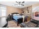 Bedroom with a black bed, wood accent wall with guitars, and an attached seating area at 2333 Sheridan Ct, Villa Rica, GA 30180