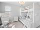 Bedroom with a white bunk bed, dresser, and a window, all in a neutral color scheme at 2333 Sheridan Ct, Villa Rica, GA 30180