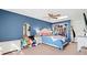 Comfortable carpeted bedroom featuring blue walls and an open closet with natural light at 2333 Sheridan Ct, Villa Rica, GA 30180