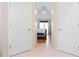 Hallway view into bedroom with vaulted ceiling, hardwood floors, and a large window at 2333 Sheridan Ct, Villa Rica, GA 30180