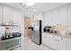 Modern kitchen with stainless steel appliances, white cabinets, and granite countertops at 2333 Sheridan Ct, Villa Rica, GA 30180