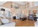 Open-concept living room with hardwood floors, a vaulted ceiling, and a view of the dining room at 2333 Sheridan Ct, Villa Rica, GA 30180