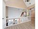 Loft view with white railing overlooking the living room and the floor-to-ceiling windows at 2333 Sheridan Ct, Villa Rica, GA 30180