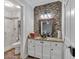 Elegant bathroom with modern vanity, stylish mirror, mosaic backsplash, and updated shower with glass door at 360 Chimney Ct, Fairburn, GA 30213