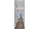 Hallway featuring farmhouse doors and access to bathroom at 360 Chimney Ct, Fairburn, GA 30213