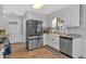 Well-appointed kitchen with stainless steel refrigerator, farmhouse sink, and pantry door at 360 Chimney Ct, Fairburn, GA 30213