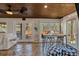 The living room features a wood ceiling, flagstone floors, and multiple windows providing natural light and views at 360 Chimney Ct, Fairburn, GA 30213