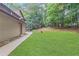 Spacious backyard featuring lush green grass and serene wooded area at 3625 N Berkeley Lake Nw Rd, Berkeley Lake, GA 30096