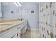 Bathroom with a large vanity, ample counter space, and decorative shower curtain at 3625 N Berkeley Lake Nw Rd, Berkeley Lake, GA 30096