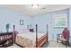 Cozy bedroom with a four-poster bed, light blue walls, and carpet at 3625 N Berkeley Lake Nw Rd, Berkeley Lake, GA 30096