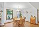 Inviting dining room with a round wooden table, chairs, and a decorative chandelier at 3625 N Berkeley Lake Nw Rd, Berkeley Lake, GA 30096