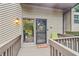 Welcoming front porch with a cozy entrance featuring a decorated front door at 3625 N Berkeley Lake Nw Rd, Berkeley Lake, GA 30096