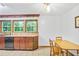 Bright kitchen featuring wooden cabinets, granite counters, and a sleek dishwasher at 3625 N Berkeley Lake Nw Rd, Berkeley Lake, GA 30096