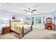 Bright main bedroom with a bay window, ceiling fan, and ample natural light at 3625 N Berkeley Lake Nw Rd, Berkeley Lake, GA 30096