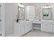 Bathroom featuring double vanity sink, quartz countertops, storage cabinets, and a large frameless mirror at 3790 Chattahoochee (Lot 33) Rd, Cumming, GA 30041