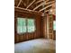 Framed bedroom with windows showing views of nature and trees in the distance at 3790 Chattahoochee (Lot 33) Rd, Cumming, GA 30041