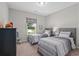 Neutral-toned bedroom with two twin beds featuring gray headboards and matching striped bedding sets at 3790 Chattahoochee (Lot 33) Rd, Cumming, GA 30041