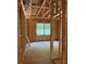 Partially framed bedroom with view to outdoors, showing window and wall construction progress at 3790 Chattahoochee (Lot 33) Rd, Cumming, GA 30041