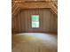 A framed bedroom with high ceilings and a window, representing the early stages of building at 3790 Chattahoochee (Lot 33) Rd, Cumming, GA 30041