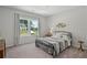 Cozy bedroom with large window offering an exterior view of a green, well maintained lawn and neighborhood home at 3790 Chattahoochee (Lot 33) Rd, Cumming, GA 30041