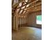 Spacious bedroom with vaulted ceiling, exposed beams, and a window showing outdoor greenery at 3790 Chattahoochee (Lot 33) Rd, Cumming, GA 30041