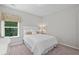 Bright bedroom featuring a white headboard, neutral-toned bedding and decor and a large window at 3790 Chattahoochee (Lot 33) Rd, Cumming, GA 30041