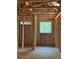 Framed bedroom featuring a window that lets in natural light, highlighting the construction phase at 3790 Chattahoochee (Lot 33) Rd, Cumming, GA 30041