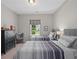 Bright bedroom with two twin beds, a dark dresser, and a window overlooking the yard at 3790 Chattahoochee (Lot 33) Rd, Cumming, GA 30041