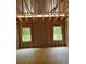 Bedroom framing with natural light streaming through dual windows, showing construction progress at 3790 Chattahoochee (Lot 33) Rd, Cumming, GA 30041
