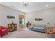 Bonus room with a sofa, a vintage popcorn machine, and pops of colors with a view outside the window at 3790 Chattahoochee (Lot 33) Rd, Cumming, GA 30041