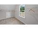 Empty closet showing wire shelving, neutral color scheme, and large window for natural light at 3790 Chattahoochee (Lot 33) Rd, Cumming, GA 30041