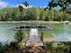 Covered boat dock and boat slip featuring a walkway to the dock at 3790 Chattahoochee (Lot 33) Rd, Cumming, GA 30041