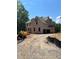 Two-story home under construction featuring an unfinished gravel driveway and wooded backdrop at 3790 Chattahoochee (Lot 33) Rd, Cumming, GA 30041