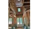 Unfinished home's entryway featuring double glass doors, a window above, and exposed beams at 3790 Chattahoochee (Lot 33) Rd, Cumming, GA 30041