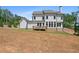 Back of home showcasing the expansive lawn, walkout basement and outdoor wooden deck at 3790 Chattahoochee (Lot 33) Rd, Cumming, GA 30041