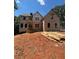 New two-story home under construction with a covered porch and visible framework and materials at 3790 Chattahoochee (Lot 33) Rd, Cumming, GA 30041