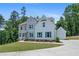 Attractive two-story house with a detached garage, surrounded by lush greenery and a manicured lawn at 3790 Chattahoochee (Lot 33) Rd, Cumming, GA 30041